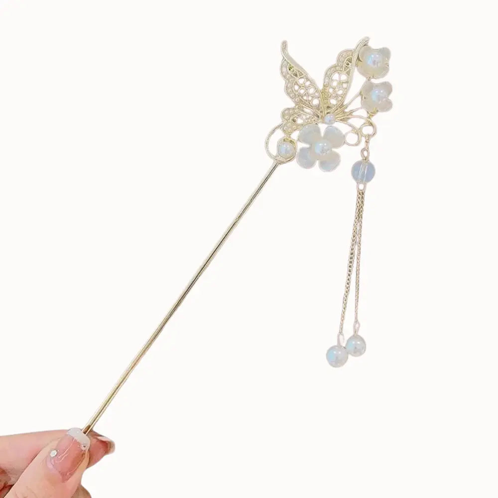 Bijou de cheveux doré à motifs floraux et perles nacrées.