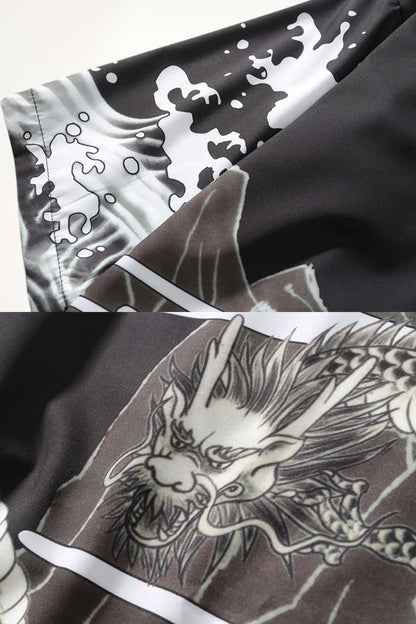 Détail d'un kimono moderne noir avec motifs de dragon et vagues blanches sur un tissu satiné