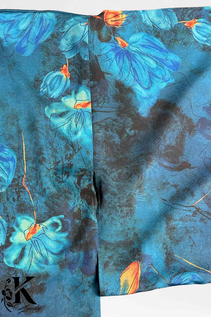 Tissu de kimono bleu avec motifs floraux éclatants sur fond sombre, créant une ambiance élégante et mystérieuse