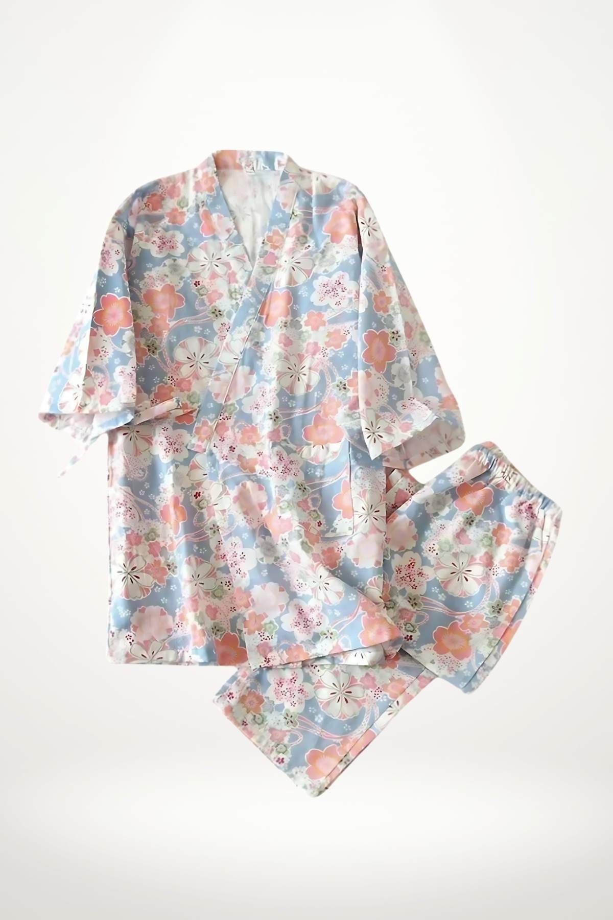 Kimono pyjama femme aux motifs floraux colorés sur fond bleu, avec manches larges et pantalon assorti