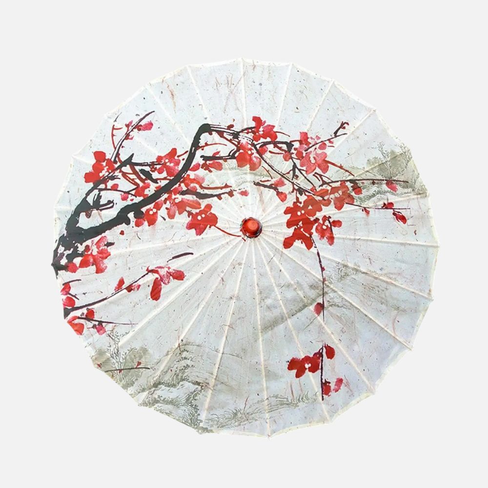 Ombrelle japonaise blanche ornée de motifs floraux rouges et noirs, posée sur un fond neutre