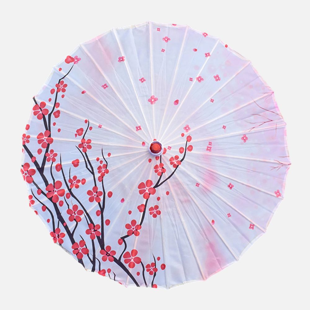 Parasol ombrelle japonais blanc orné de motifs floraux rouges sur un fond délicat et léger