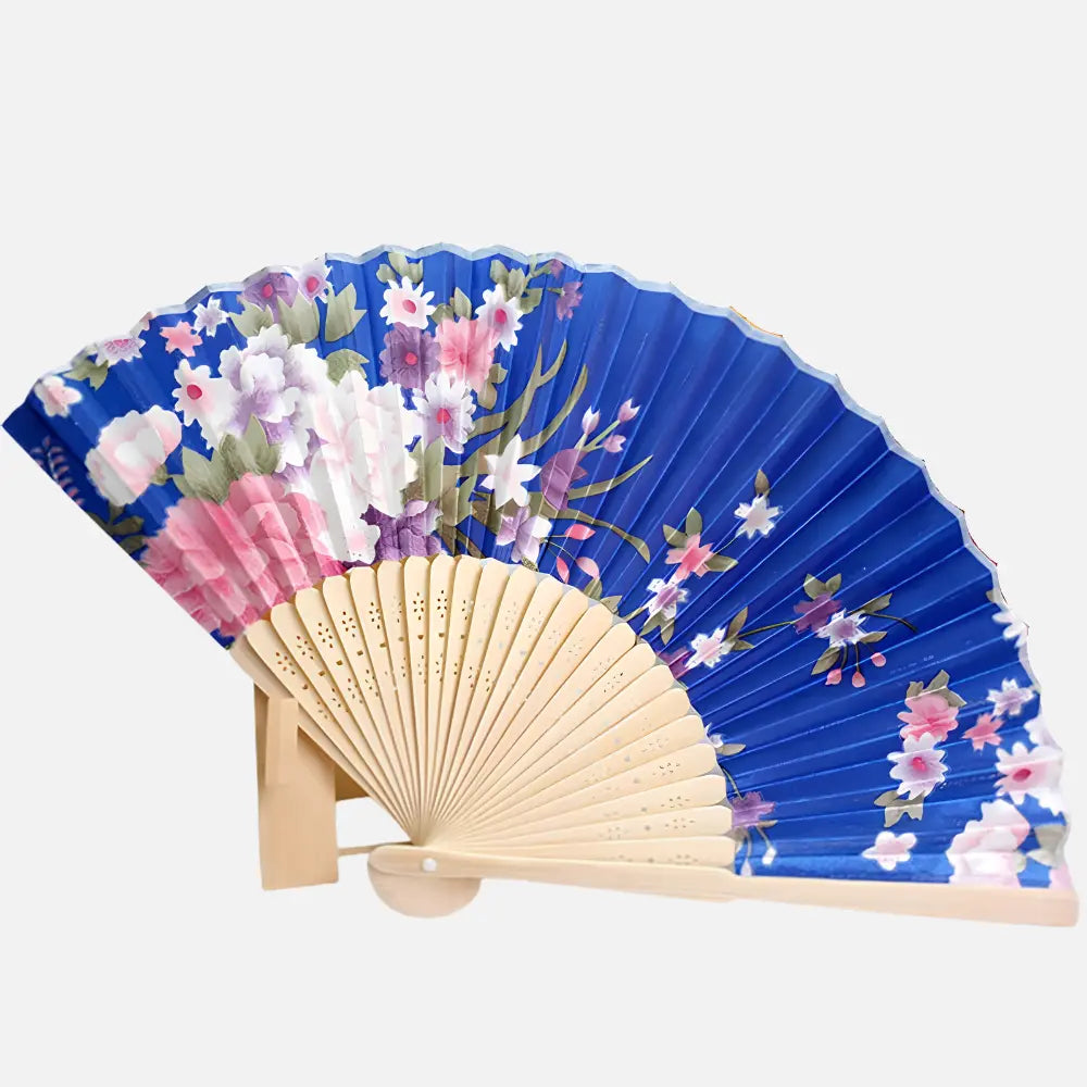 Éventail en papier bleu orné de fleurs roses et blanches, posé sur un support en bois naturel