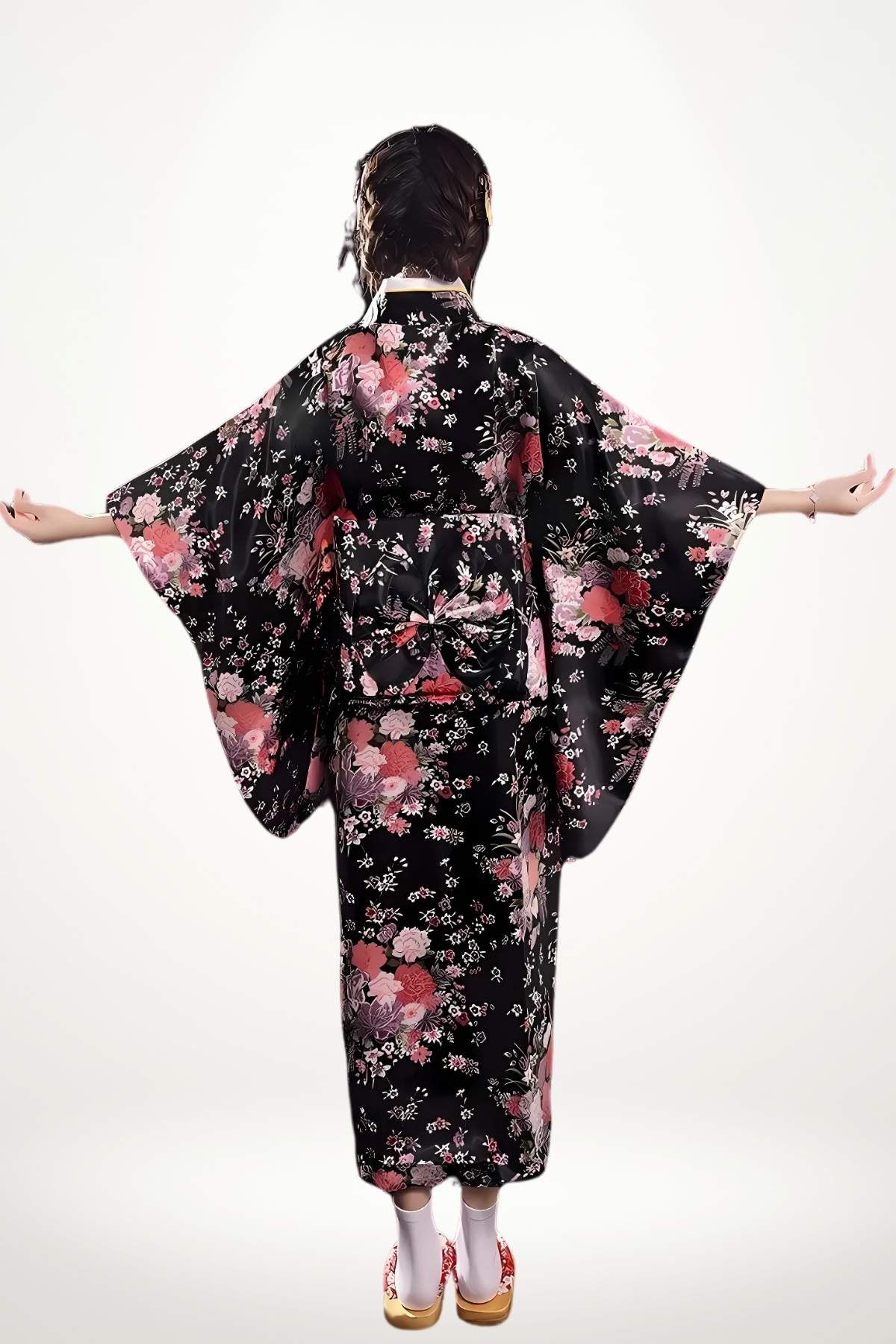 Femme en kimono noir à motifs floraux roses, bras étendus, sur fond clair, avec des sandales traditionnelles