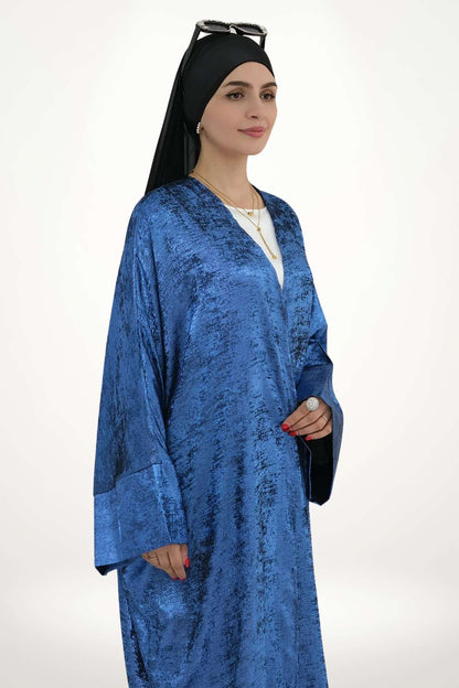 Abaya kimono satin fluide pour femme, confectionnée en velours texturé bleu. Style élégant et moderne pour exprimer une féminité pure et affirmée.
