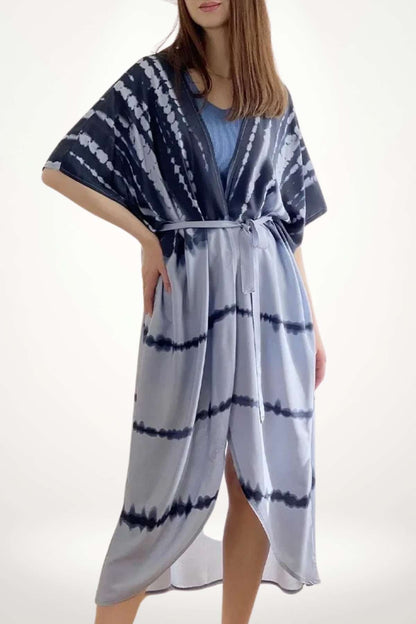 Kimono léger en dégradé bleu et blanc, avec un motif tie-dye, drapé élégamment sur une silhouette féminine