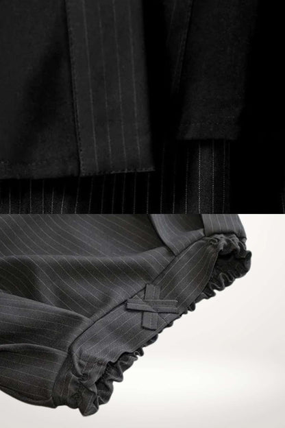 Détail d'un kimono enfant traditionnel noir avec des rayures fines et des finitions froncées sur les manches