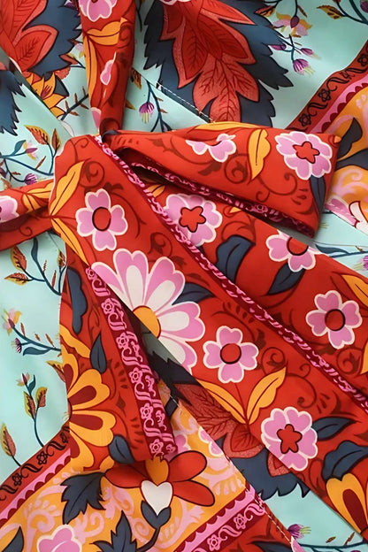 Tissu de kimono aux motifs floraux colorés, avec des tons rouges, roses et verts sur fond bleu clair