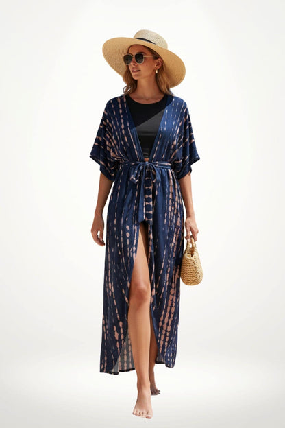 Femme marchant pieds nus, vêtue d'un kimono bleu marine à motifs roses, portant un chapeau de paille et des lunettes