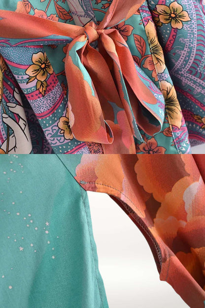 Détail d'un kimono mi-long aux motifs floraux colorés, avec un lien en satin orange et une matière fluide