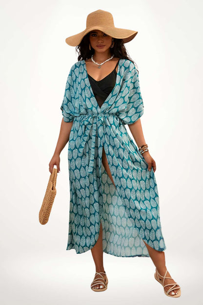 Femme portant un kimono bleu à motifs de feuilles, avec un chapeau large et un sac en osier, sur fond