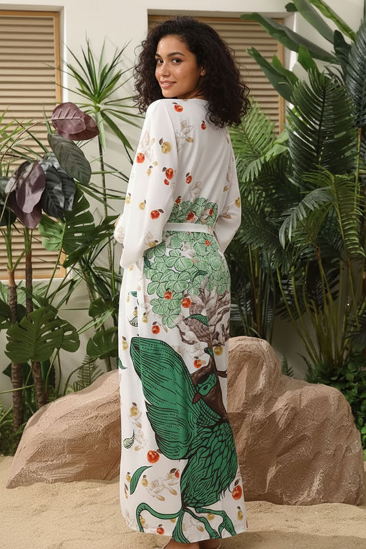 femme portant un Kimono en satin blanc avec motifs verts de paon et fruits, dans un décor lumineux