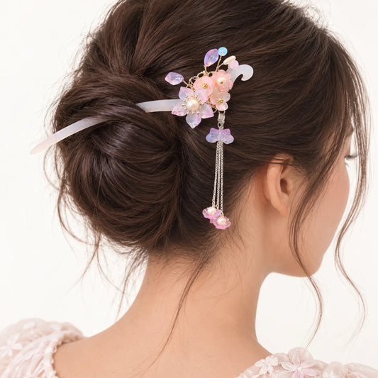 Chignon orné d’un peigne à bouquet rose et détails cristallins.