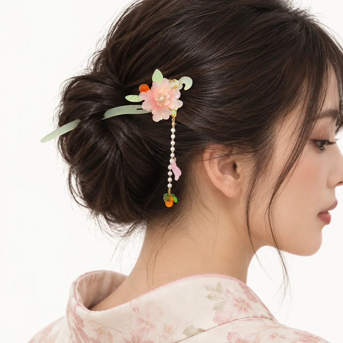 Chignon orné d’un peigne à fleur rose pêche et perles.