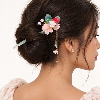 Chignon orné d’un peigne à feuilles et ornements pastel.